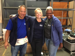 Volunteers Roy Morizawa (left) and Sophonia Shield (right) with Karen Moore (center)