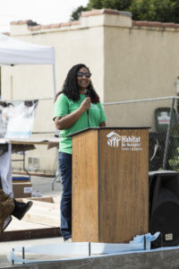 Tianna-Nichole Jordan giving a speech at a podium.