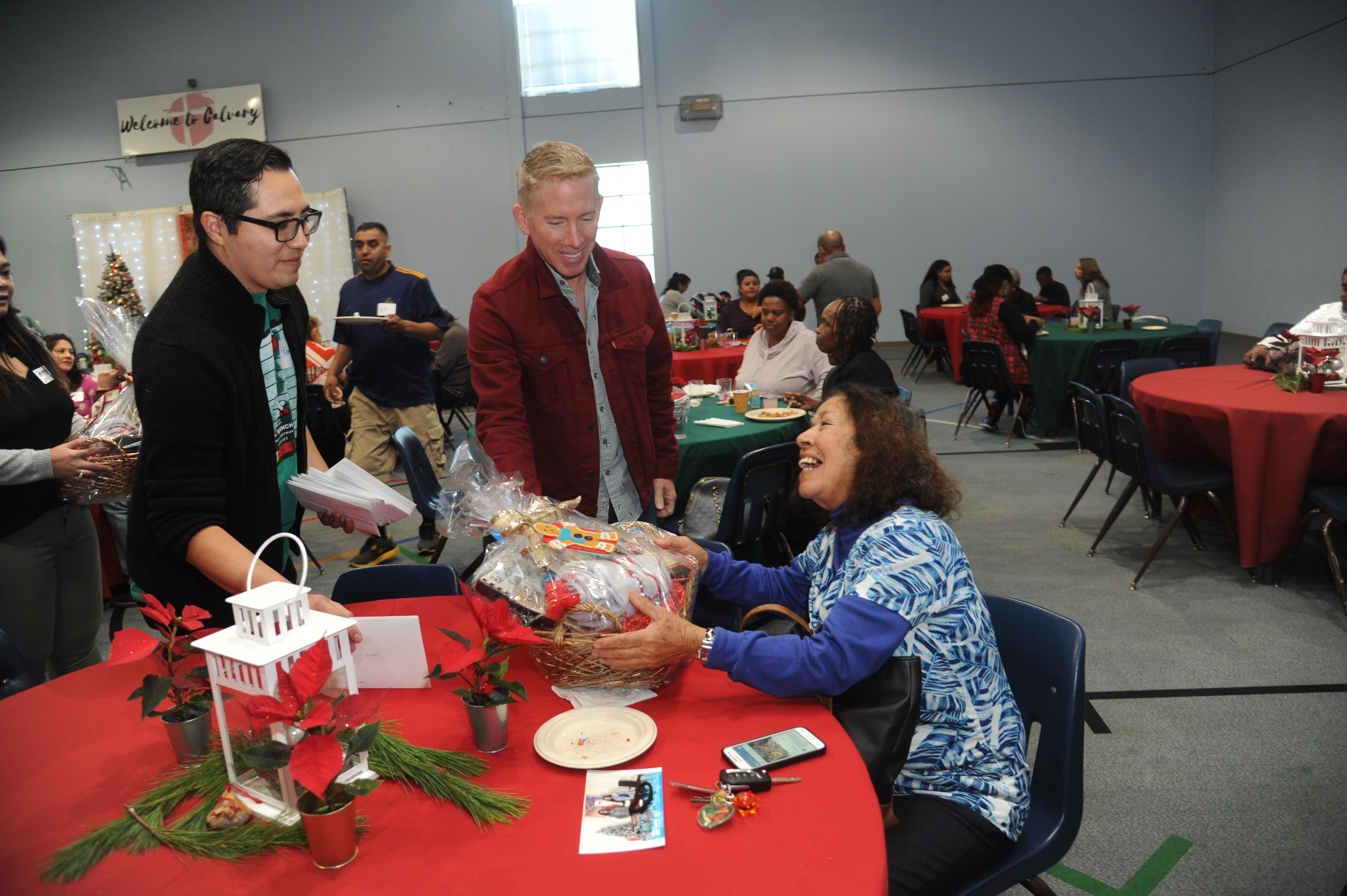 A lady receiving a gift at the event while smiling.