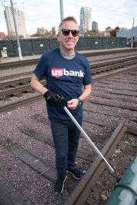 Carl Jordan smiling while picking up trash.