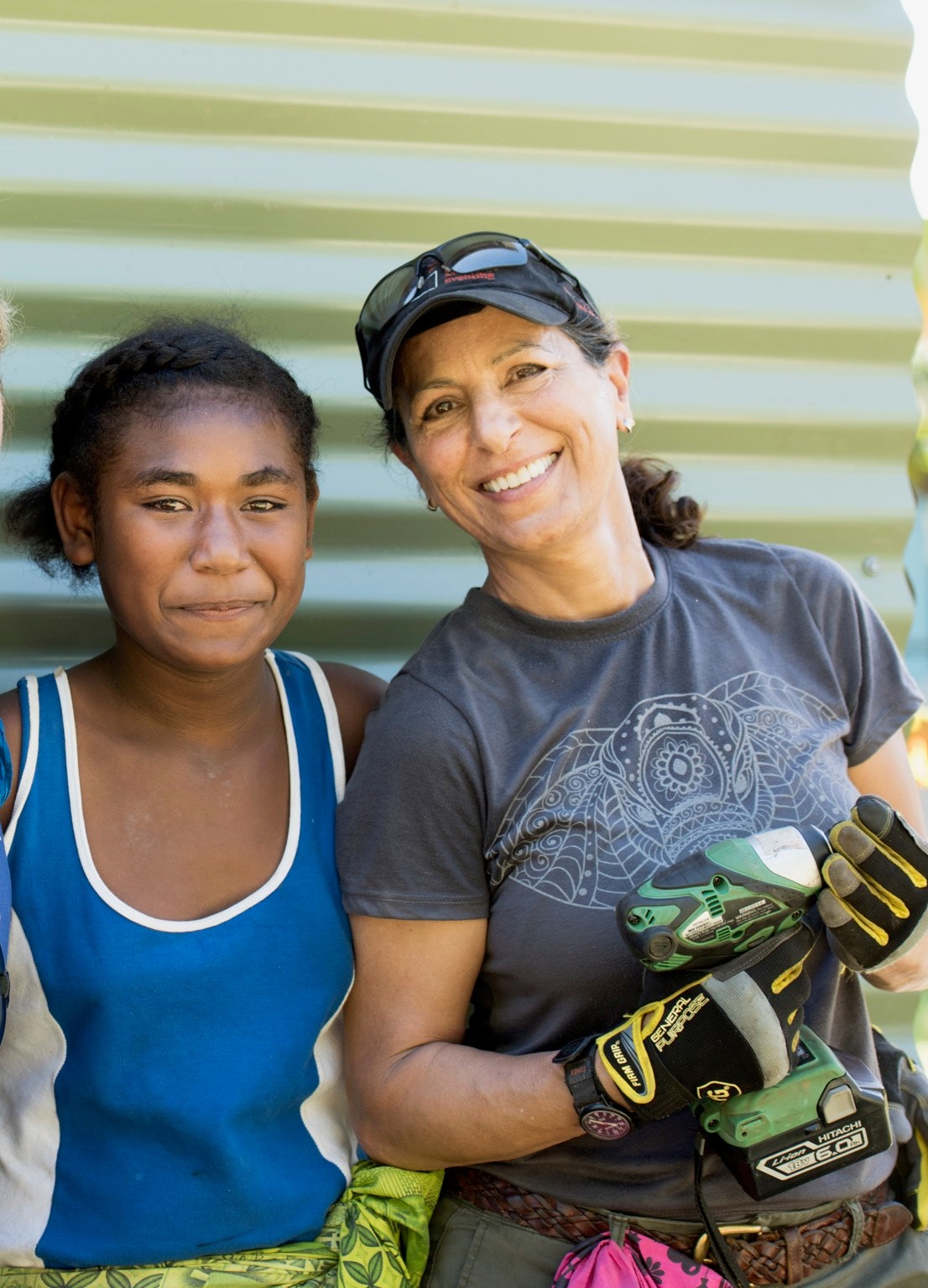 Michelle Meghrouni smiling for a photo with a girl as she volunteers on site.