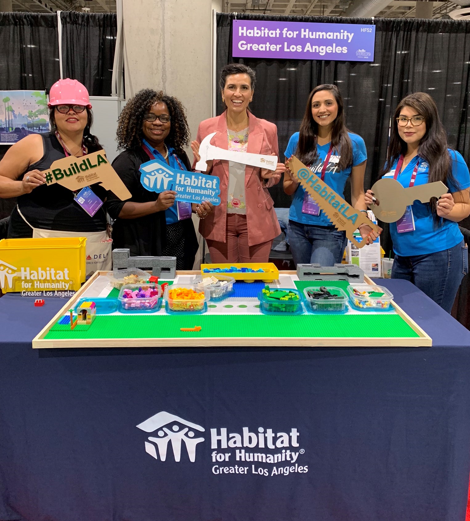 a group photo of Habitat LA staff at an event with Veronica Melvin, LA Promise Fund President and CEO